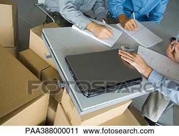 Stock Photography - three business 
men working at 
table,  surrounded 
by cardboard boxes. 
fotosearch - search 
stock photos, 
pictures, images, 
and photo clipart