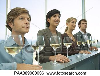 Stock Photo - four adults standing 
in row with hands 
on bar,  glasses 
of wine in. fotosearch 
- search stock 
photos, pictures, 
images, and photo 
clipart
