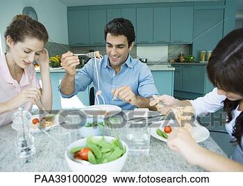 Stock Photograph - family having 
meal together. 
fotosearch - search 
stock photos, 
pictures, images, 
and photo clipart