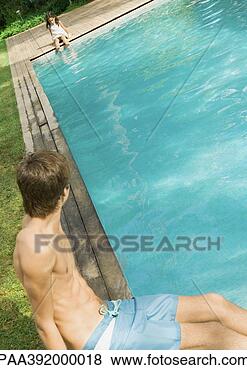 Stock Photo - boy sitting at 
edge of pool, 
 looking at little 
girl at other 
end of. fotosearch 
- search stock 
photos, pictures, 
images, and photo 
clipart