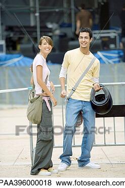 Stock Photo - teen couple standing, 
smiling at camera. 
fotosearch - search 
stock photos, 
pictures, images, 
and photo clipart