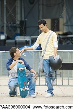 Stock Photo - teen males, one 
with skateboard 
the other holding 
helmet. fotosearch 
- search stock 
photos, pictures, 
images, and photo 
clipart