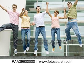 Stock Photography - teens holding 
hands and jumping 
in the air. fotosearch 
- search stock 
photos, pictures, 
images, and photo 
clipart