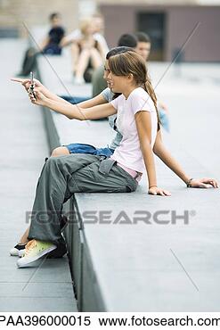 Stock Image - teens sitting 
outdoors in urban 
area. fotosearch 
- search stock 
photos, pictures, 
images, and photo 
clipart