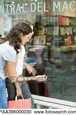 Stock Photography - two teen girls 
looking into shop 
window of book 
store. fotosearch 
- search stock 
photos, pictures, 
images, and photo 
clipart
