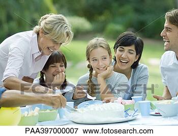 Picture - family having 
outdoor birthday 
party. fotosearch 
- search stock 
photos, pictures, 
images, and photo 
clipart