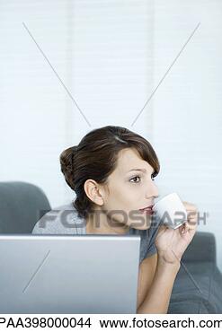Stock Photo - woman using laptop 
and sipping coffee. 
fotosearch - search 
stock photos, 
pictures, images, 
and photo clipart