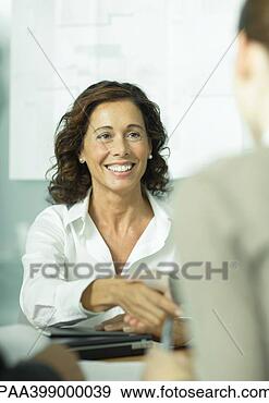 Stock Photograph - professional woman 
shaking hands 
with second woman. 
fotosearch - search 
stock photos, 
pictures, images, 
and photo clipart