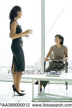 Stock Photo - two women talking 
in lobby. fotosearch 
- search stock 
photos, pictures, 
images, and photo 
clipart