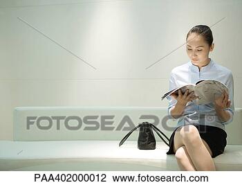 Stock Photo - businesswoman 
sitting, reading 
magazine in waiting 
room. fotosearch 
- search stock 
photos, pictures, 
images, and photo 
clipart