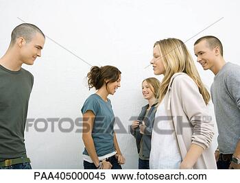 Stock Image - group of casually 
dressed young 
adults,  moving 
toward each other. 
fotosearch - search 
stock photos, 
pictures, images, 
and photo clipart