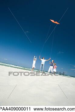 Stock Photography - family flying 
kite on beach. 
fotosearch - search 
stock photos, 
pictures, images, 
and photo clipart