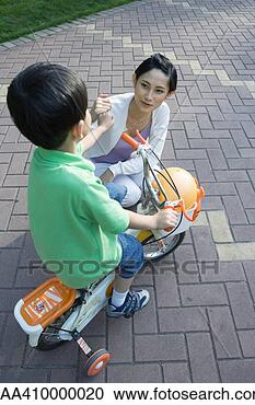 Stock Photography - boy on bike with 
training wheels 
and mother. fotosearch 
- search stock 
photos, pictures, 
images, and photo 
clipart