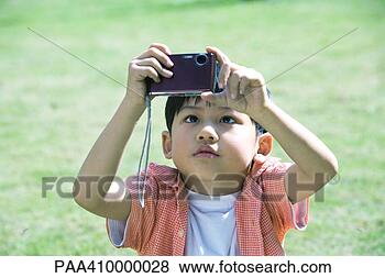 Stock Photo - boy using digital 
camera. fotosearch 
- search stock 
photos, pictures, 
images, and photo 
clipart