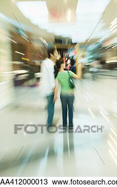 Stock Photo - couple walking 
through shopping 
mall,  rear view, 
 full length. 
fotosearch - search 
stock photos, 
pictures, images, 
and photo clipart