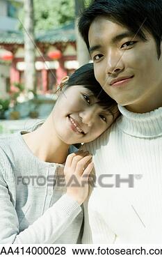 Stock Photo - couple smiling 
at camera, woman 
resting head on 
man's shoulder. 
fotosearch - search 
stock photos, 
pictures, images, 
and photo clipart