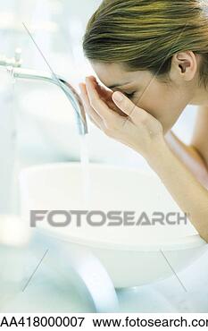 Picture - woman washing 
face over sink. 
fotosearch - search 
stock photos, 
pictures, images, 
and photo clipart