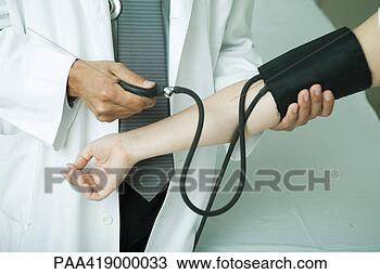 Stock Photo - doctor taking 
patient's blood 
pressure. fotosearch 
- search stock 
photos, pictures, 
images, and photo 
clipart