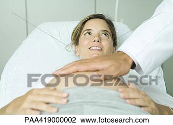 Stock Photo - pregnant woman 
lying on back 
in doctor's office, 
 doctor's hand 
on. fotosearch 
- search stock 
photos, pictures, 
images, and photo 
clipart