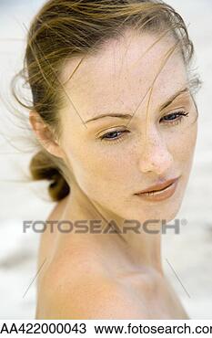 Stock Photo - woman looking 
over shoulder, 
 hair being tousled 
by the wind,  
head. fotosearch 
- search stock 
photos, pictures, 
images, and photo 
clipart