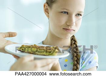 Stock Photo - hands holding 
up slice of quiche 
toward girl,  
girl making face 
and. fotosearch 
- search stock 
photos, pictures, 
images, and photo 
clipart