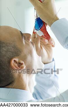 Stock Photo - man holding up 
package of food 
above open mouth. 
fotosearch - search 
stock photos, 
pictures, images, 
and photo clipart