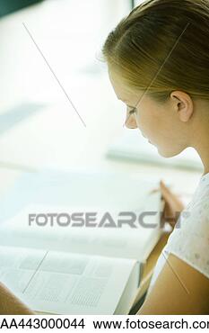 Stock Photo - female college 
student sitting 
at table in library, 
studying. fotosearch 
- search stock 
photos, pictures, 
images, and photo 
clipart