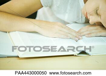 Stock Photography - female college 
student sitting 
with head on book, 
close-up. fotosearch 
- search stock 
photos, pictures, 
images, and photo 
clipart