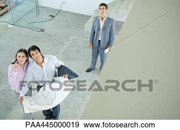 Stock Photograph - male real estate 
agent standing 
in home interior 
with young couple. 
fotosearch - search 
stock photos, 
pictures, images, 
and photo clipart