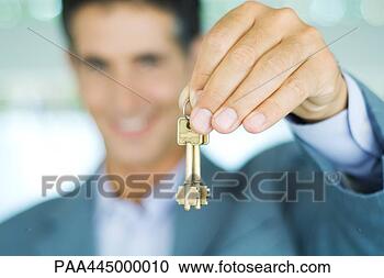 Stock Photography - man in suit holding 
up keys, focus 
on hand holding 
keys in foreground. 
fotosearch - search 
stock photos, 
pictures, images, 
and photo clipart