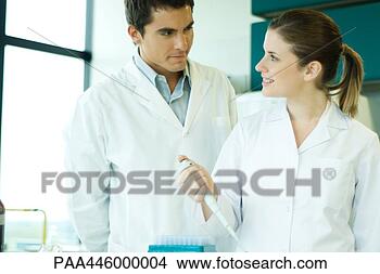 Stock Photo - young female lab 
worker smiling 
at supervisor. 
fotosearch - search 
stock photos, 
pictures, images, 
and photo clipart