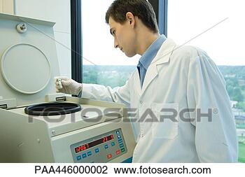 Stock Photo - young male scientist 
using centrifuge. 
fotosearch - search 
stock photos, 
pictures, images, 
and photo clipart