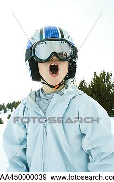 Stock Photograph - boy wearing helmet 
and ski goggles, 
snow-covered, 
open mouth. fotosearch 
- search stock 
photos, pictures, 
images, and photo 
clipart