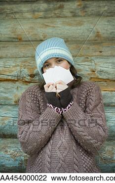 Stock Photo - teenage girl looking 
over cards, dressed 
in winter clothing, 
portrait. fotosearch 
- search stock 
photos, pictures, 
images, and photo 
clipart
