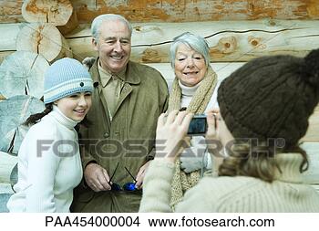 Stock Photo - teenage girl photographing 
grandparents and 
sister with digital. 
fotosearch - search 
stock photos, 
pictures, images, 
and photo clipart