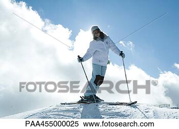 Stock Image - young female skier 
standing on top 
of ski slope, 
full length portrait. 
fotosearch - search 
stock photos, 
pictures, images, 
and photo clipart