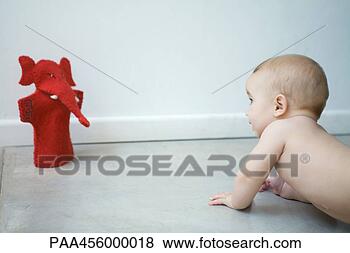 Stock Photo - naked baby crawling 
on floor, looking 
at puppet, waist 
up. fotosearch 
- search stock 
photos, pictures, 
images, and photo 
clipart