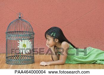 Stock Photo - girl lying on 
floor, looking 
at flower in birdcage, 
side view. fotosearch 
- search stock 
photos, pictures, 
images, and photo 
clipart