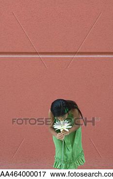 Picture - girl standing, 
bending over, 
smelling flower. 
fotosearch - search 
stock photos, 
pictures, images, 
and photo clipart