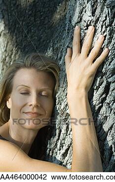 Stock Photo - woman hugging 
tree, eyes closed, 
smiling, head 
and shoulders. 
fotosearch - search 
stock photos, 
pictures, images, 
and photo clipart