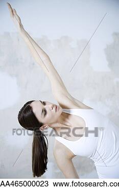Stock Photo - woman stretching, 
one arm raised, 
looking up. fotosearch 
- search stock 
photos, pictures, 
images, and photo 
clipart