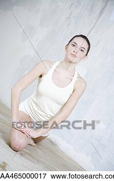 Picture - young woman stretching, 
smiling at camera, 
tilted view. fotosearch 
- search stock 
photos, pictures, 
images, and photo 
clipart