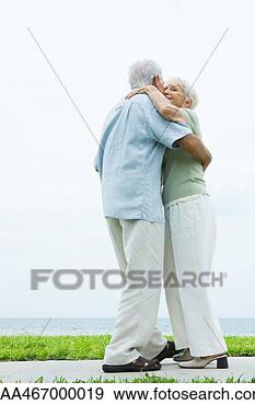 Stock Photograph - senior couple 
dancing on sidewalk 
overlooking ocean, 
full length. fotosearch 
- search stock 
photos, pictures, 
images, and photo 
clipart