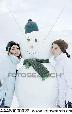 Stock Photo - two teen girls 
leaning against 
snowman. fotosearch 
- search stock 
photos, pictures, 
images, and photo 
clipart