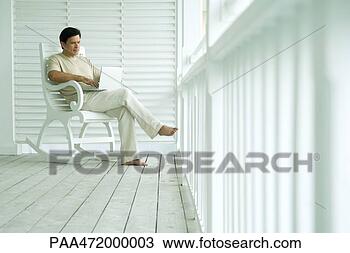 Stock Photo - man using laptop 
computer on porch. 
fotosearch - search 
stock photos, 
pictures, images, 
and photo clipart