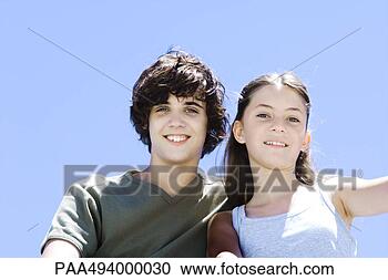 Stock Photography - brother and sister 
smiling at camera, 
low angle view, 
portrait. fotosearch 
- search stock 
photos, pictures, 
images, and photo 
clipart