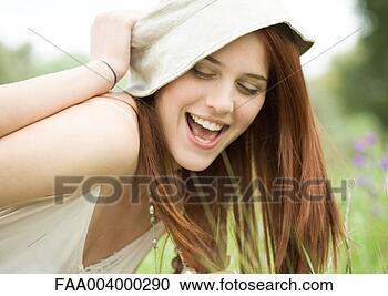 Stock Photography - young woman having 
hat pulled off. 
fotosearch - search 
stock photos, 
pictures, images, 
and photo clipart