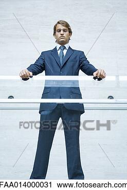 Stock Photography - businessman standing 
with hands resting 
on transparent 
guard rail. fotosearch 
- search stock 
photos, pictures, 
images, and photo 
clipart