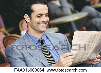 Stock Photo - businessman sitting 
in sidewalk cafe, 
reading financial 
pages, smiling. 
fotosearch - search 
stock photos, 
pictures, images, 
and photo clipart