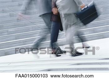 Stock Photo - businessman and 
woman walking, 
waist down, blurred 
motion. fotosearch 
- search stock 
photos, pictures, 
images, and photo 
clipart